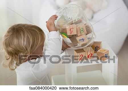 Baby dumping blocks out View Large Photo Image Stock Image - Baby dumping blocks out. Fotosearch