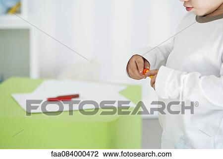 Baby holding crayons, mid section View Large Photo Image Stock Image - Baby holding crayons, mid section. Fotosearch