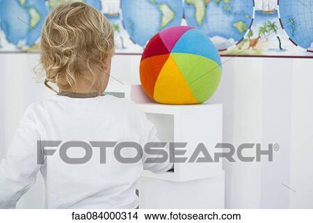 Baby playing in nursery, rear view View Large Photo Image Picture - Baby playing in nursery, rear view. Fotosearch