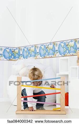Baby playing with toy View Large Photo Image Stock Image - Baby playing with toy. Fotosearch