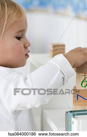 Stock Photograph - Baby stacking blocks. Fotosearch