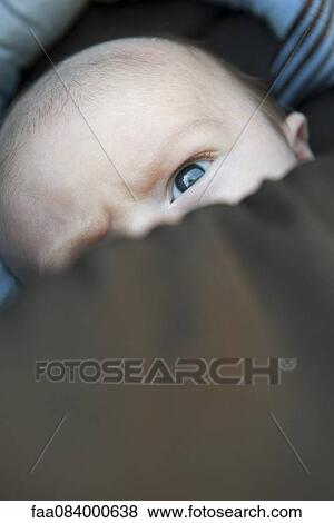 Baby with face partially covered by blanket View Large Photo Image Stock Photo - Baby with face partially covered by blanket. Fotosearch