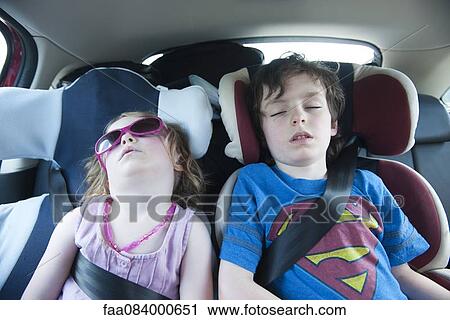 Boy and girl asleep in car seats View Large Photo Image Stock Image - Boy and girl asleep in car seats. Fotosearch