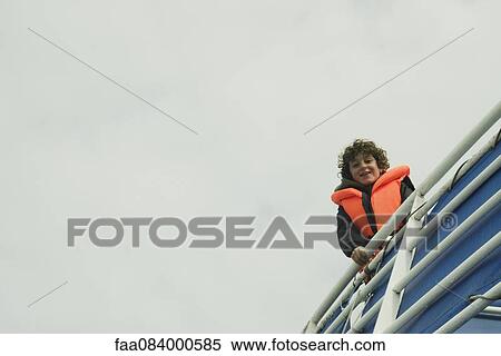 Boy in a lifejacket on a boat, Reykjavik Iceland View Large Photo Image Stock Photography - Boy in a lifejacket on a boat, Reykjavik Iceland. Fotosearch