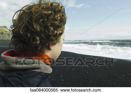 Boy looking horizon facing the sea, iceland View Large Photo Image Stock Photography - Boy looking horizon facing the sea, iceland. Fotosearch