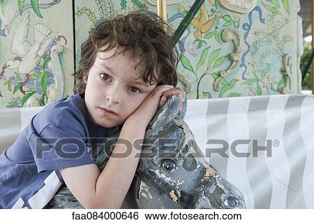 Boy riding amusement park ride, portrait View Large Photo Image Stock Photograph - Boy riding amusement park ride, portrait. Fotosearch