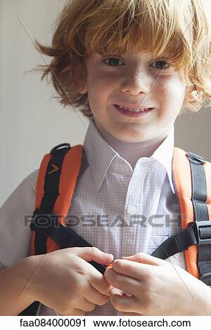 Stock Image - Boy wearing backpack, portrait. Fotosearch