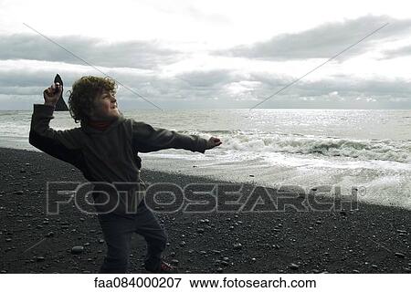 Boy who ricochets on the beach Iceland View Large Photo Image Stock Photo - Boy who ricochets on the beach Iceland. Fotosearch