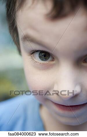 Boy with eyebrow raised, cropped portrait View Large Photo Image Stock Image - Boy with eyebrow raised, cropped portrait. Fotosearch