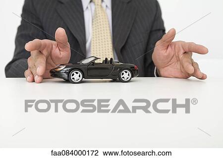 Businessman and toy car, mid section View Large Photo Image Stock Image - Businessman and toy car, mid section. Fotosearch