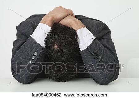 Businessman resting head on desk View Large Photo Image Stock Image - Businessman resting head on desk. Fotosearch