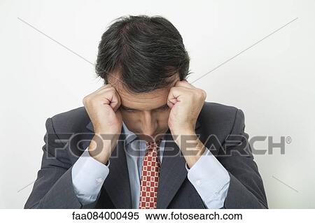 Businessman with fists on temples View Large Photo Image Stock Photography - Businessman with fists on temples. Fotosearch