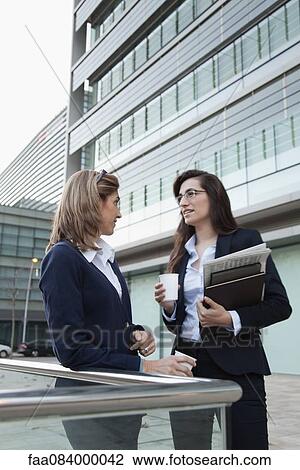 Businsswoman taking coffee break together outdoors View Large Photo Image Stock Image - Businsswoman taking coffee break together outdoors. Fotosearch
