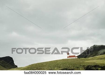 Stock Photography - Church on mountain background Vik, Iceland. Fotosearch