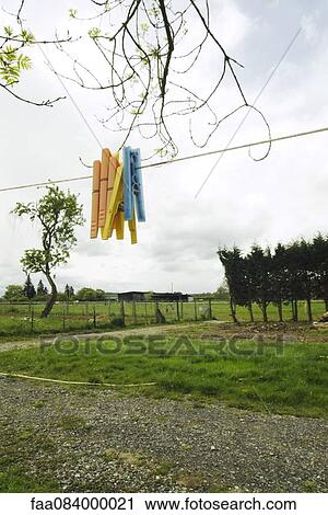 Stock Image - Clothespins on a rope in a country d? co. Fotosearch