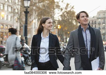 Stock Photograph - Couple walking together in street. Fotosearch