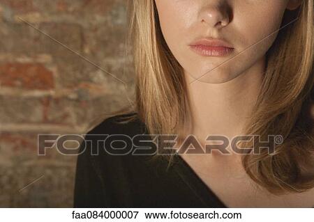 Stock Photo - Cropped portrait of young woman. Fotosearch