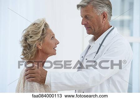 Doctor comforting patient View Large Photo Image Stock Image - Doctor comforting patient. Fotosearch