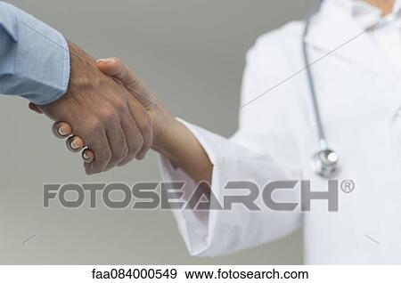 Doctor shaking patient's hand, cropped View Large Photo Image Stock Photo - Doctor shaking patient's hand, cropped. Fotosearch