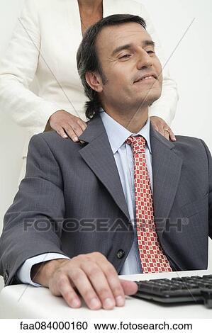 Executive enjoying shoulder massage given by colleague View Large Photo Image Stock Image - Executive enjoying shoulder massage given by colleague. Fotosearch