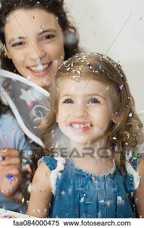 Girl looking at falling confetti View Large Photo Image Stock Photography - Girl looking at falling confetti. Fotosearch