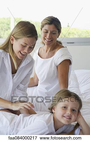 Grandmother, daughter and granddaughter relaxing together View Large Photo Image Stock Photo - Grandmother, daughter and granddaughter relaxing together. Fotosearch