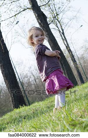 Little girl smiling outdoors, full length portrait View Large Photo Image Stock Image - Little girl smiling outdoors, full length portrait. Fotosearch