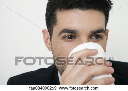 Man drinking from cup View Large Photo Image Stock Photo - Man drinking from cup. Fotosearch