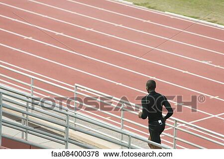 Man running bleachers View Large Photo Image Stock Photo - Man running bleachers. Fotosearch