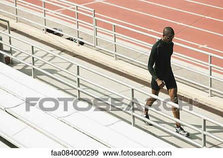 Man walking on bleacher View Large Photo Image Stock Photo - Man walking on bleacher. Fotosearch