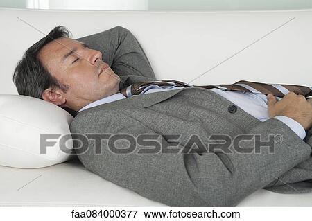 Mature businessman sleeping on couch View Large Photo Image Stock Photo - Mature businessman sleeping on couch. Fotosearch