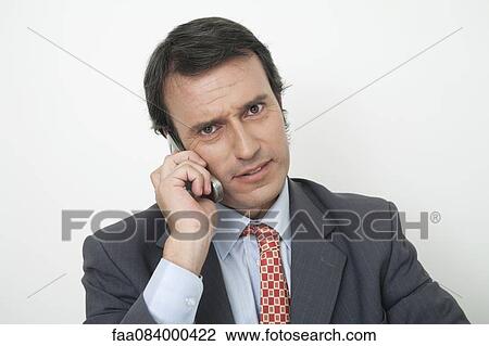 Mature businessman talking on cell phone with worried look View Large Photo Image Stock Image - Mature businessman talking on cell phone with worried look. Fotosearch