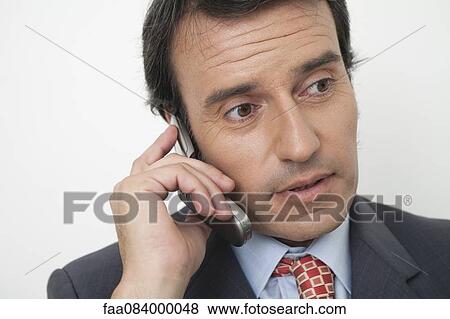 Stock Photo - Mature businessman using cell phone. Fotosearch