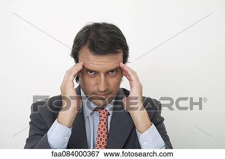 Mature businessman with hands on temples View Large Photo Image Stock Photo - Mature businessman with hands on temples. Fotosearch