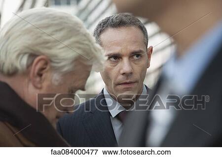 Mature businessmen talking together outdoors View Large Photo Image Stock Photo - Mature businessmen talking together outdoors. Fotosearch