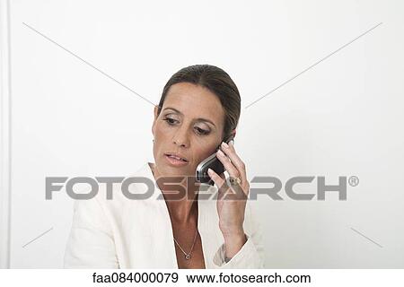 Mature businesswoman talking on cell phone View Large Photo Image Stock Photo - Mature businesswoman talking on cell phone. Fotosearch