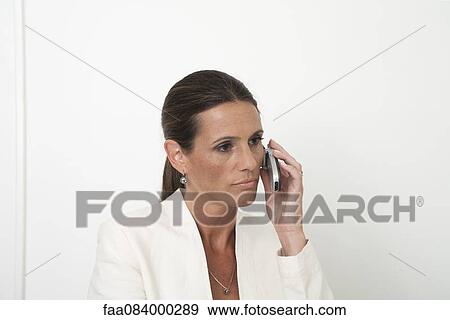 Mature businesswoman talking on cell phone View Large Photo Image Stock Photo - Mature businesswoman talking on cell phone. Fotosearch
