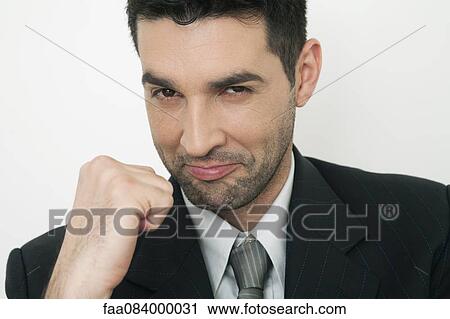 Mid-adult businessman clenching fist, smiling View Large Photo Image Stock Image - Mid-adult businessman clenching fist, smiling. Fotosearch