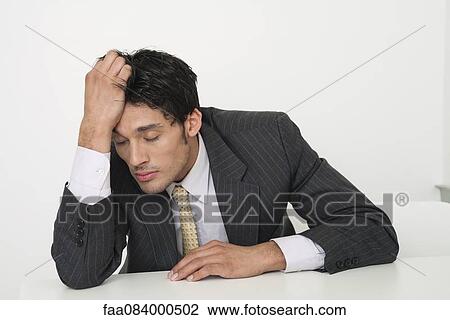 Mid-adult businessman holding head with eyes closed View Large Photo Image Stock Image - Mid-adult businessman holding head with eyes closed. Fotosearch