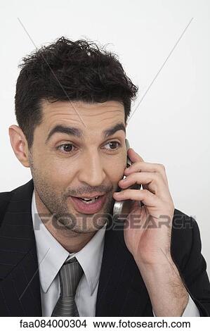 Mid-adult businessman talking on cell phone View Large Photo Image Picture - Mid-adult businessman talking on cell phone. Fotosearch