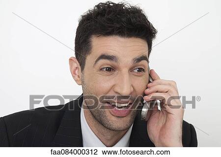 Mid-adult businessman talking on cell phone View Large Photo Image Stock Image - Mid-adult businessman talking on cell phone. Fotosearch