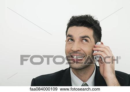 Mid-adult businessman talking on cell phone View Large Photo Image Stock Photo - Mid-adult businessman talking on cell phone. Fotosearch