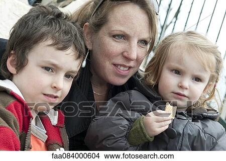Picture - Mother and children together outdoors, portrait. Fotosearch