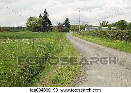 Narrow country road leading to a village View Large Photo Image Stock Image - Narrow country road leading to a village. Fotosearch