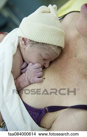 Newborn baby lying on mother's chest View Large Photo Image Picture - Newborn baby lying on mother's chest. Fotosearch