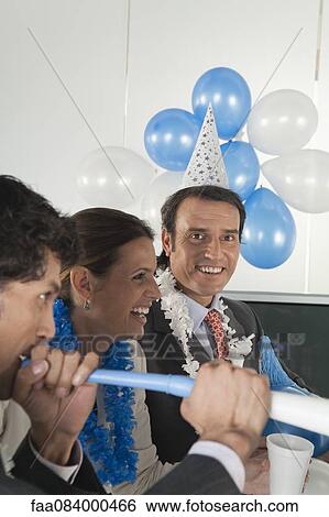 Stock Photograph - Office celebration, mature man looking at camera. Fotosearch