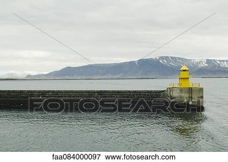 Stock Photo - Pontoon Reykjavik harbor, mountains in the background. Fotosearch