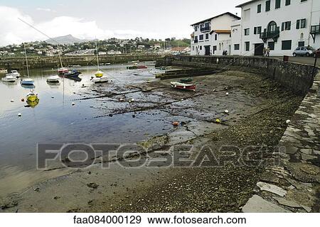 Stock Photo - Port Ciboure with Rhune overlooking the village on the horizon. Fotosearch
