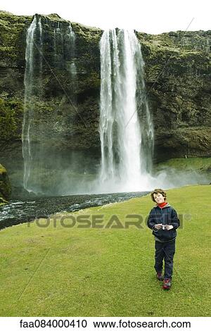 Smiling boy posing in front of a waterfall, Iceland View Large Photo Image Stock Image - Smiling boy posing in front of a waterfall, Iceland. Fotosearch