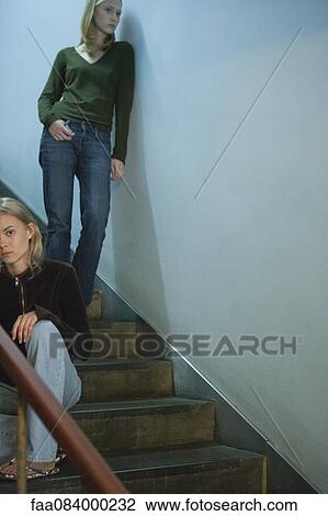 Teen girl sitting on stairs, young woman leaning on wall behind her View Large Photo Image Stock Image - Teen girl sitting on stairs, young woman leaning on wall behind her. Fotosearch